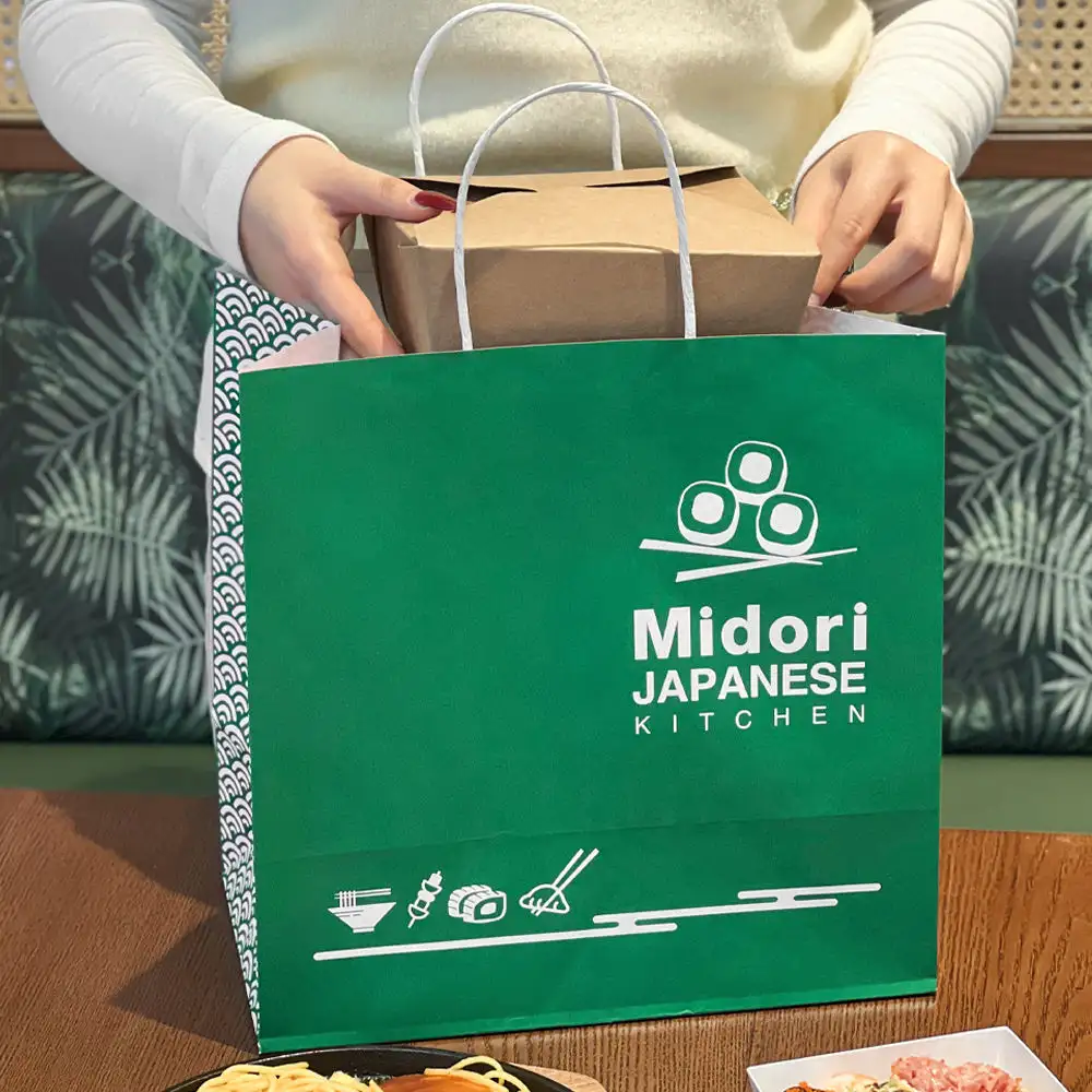 Sushi & Bento Catering Bags - Putting food container into takeaway paper bag